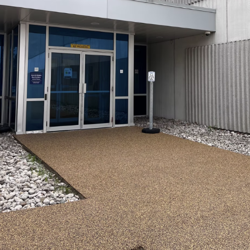 Rubber resurfacing over worn walkway concrete